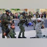 Police detain members of the New Mexico Civil Guard, an armed civilian group, following the shooting of a man during a protest over a statue of Spanish conqueror Juan de Onate in Albuquerque, New Mexico, June 15, 2020.?