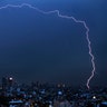 A bolt of lightning strikes during an early morning storm in Mexico City, June 22, 2020. 
