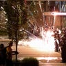 A firework explodes next to a police line as demonstrators gather to protest the death of George Floyd, near the White House in Washington, D.C., May 30, 2020. 