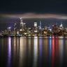 The lights of midtown Manhattan are reflected in the calm water of the Hudson River in New York City, June 3, 2020.