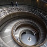 Museum employees, wearing masks to prevent the spread of coronavirus, walk down a staircase designed by Giuseppe Momo in 1932 as the Vatican Museum reopened in Rome, June 1, 2020. 