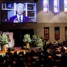 Mourners watching a video-recorded message by former Vice President Joe Biden. "No child should have to ask questions that too many black children have had to ask for generations: Why?" Biden said. "Now is the time for racial justice. That is the answer we must give to our children when they ask why."