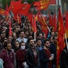 Athens, Greece: Members of the Greek Communist Party (KKE) youth organization, holding various flags march outside the U.S. embassy in Athens, Monday, June 1, 2020, to protest against the killing of George Floyd in Minneapolis, USA.