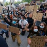 Protesters kneeling in front of a police officer during a demonstration June 1 in Salt Lake City. 