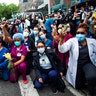 Health workers taking a knee in solidarity with protesters June 2 in New York City.