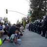 People kneeling in front of a line of California Highway Patrol officers in Redwood City, Calif., on June 2.
