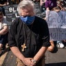 Demonstrators kneeling in prayer along 16th Street near Lafayette Park and the White House on June 3 in Washington, DC.