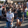 Protesters kneeling and raising their arms in Redwood City, Calif., on June 2.