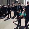 New York City police arresting a demonstrator during an Earth Day protest on Monday, April 23, 1990, in New York's Financial District. Police closed part of Wall Street to traffic and most pedestrians and arrested more than 170 demonstrators who staged a protest aimed at disrupting business in the financial center.