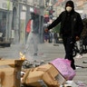 Protesters and others burning trash and ransacking a popular shopping street in Brussels. 