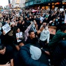 Demonstrators holding placards in central Auckland, New Zealand.