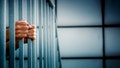A prisoner behind the jail cell bars. - Fox News