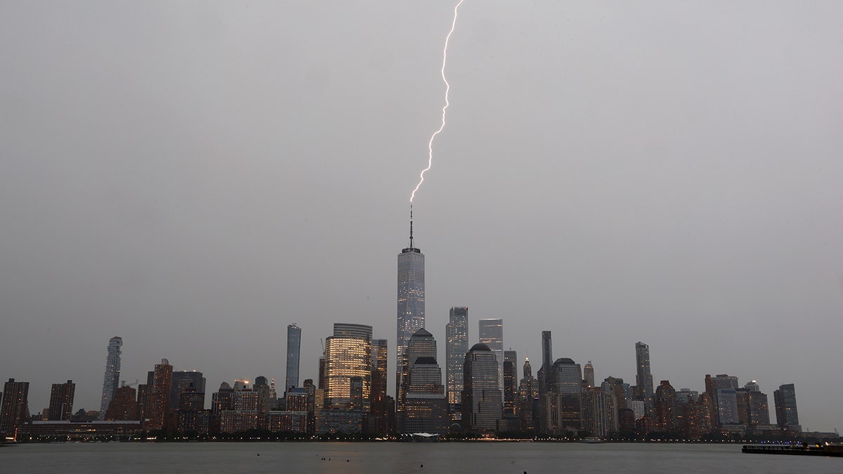JERSEY CITY, NJ - JULY 22: A bolt of lightning hits One World Trade Center in lower Manhattan during a thunderstorm in New York City on July 22, 2020 as seen from Jersey City, NJ. (Photo by Gary Hershorn/Getty Images)