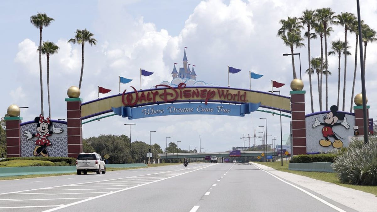 Cars drive under a sign greeting visitors near the entrance to Walt Disney World, Thursday, July 2, 2020, in Lake Buena Vista, Fla. Despite a huge surge of Floridians testing positive for the new coronavirus in recent weeks, Magic Kingdom and Animal Kingdom, two of Disney World's four parks are reopening Saturday, July 11. When they do, visitors to “The Most Magical Place on Earth” will find new rules in place.