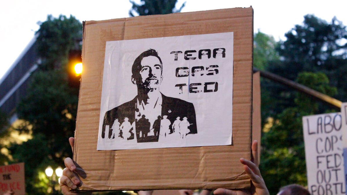 Demonstrators protest in downtown Portland, Ore., Wednesday, July 22, 2020. (AP Photo/Gillian Flaccus)