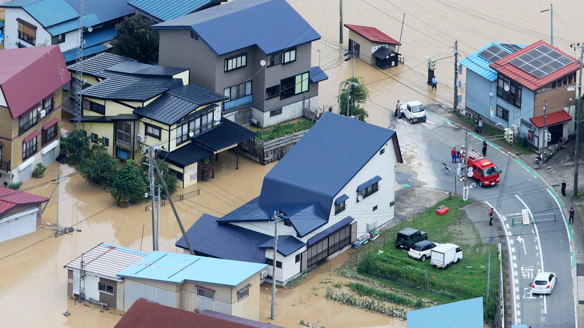 A residential area is flooded following a heavy rain in Okura village, Yamagata prefecture, northern Japan Wednesday, July 29, 2020.