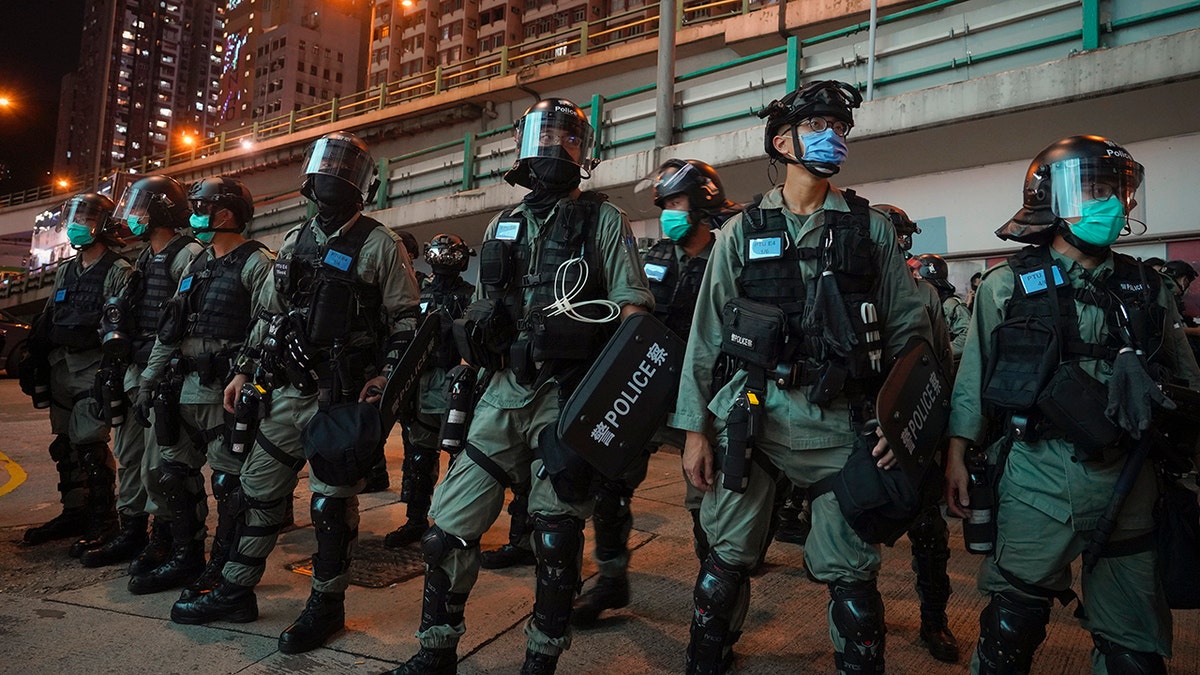 Riot police stand guard after pushing back protesters demonstrating against the new security law during the anniversary of the Hong Kong handover from Britain, Wednesday, July. 1, 2020, in Hong Kong. Hong Kong police have made their first arrests under a new national security law imposed by mainland China. The law, which took effect Tuesday night, makes activities deemed subversive or secessionist punishable by up to life in prison. (AP Photo/Vincent Yu)