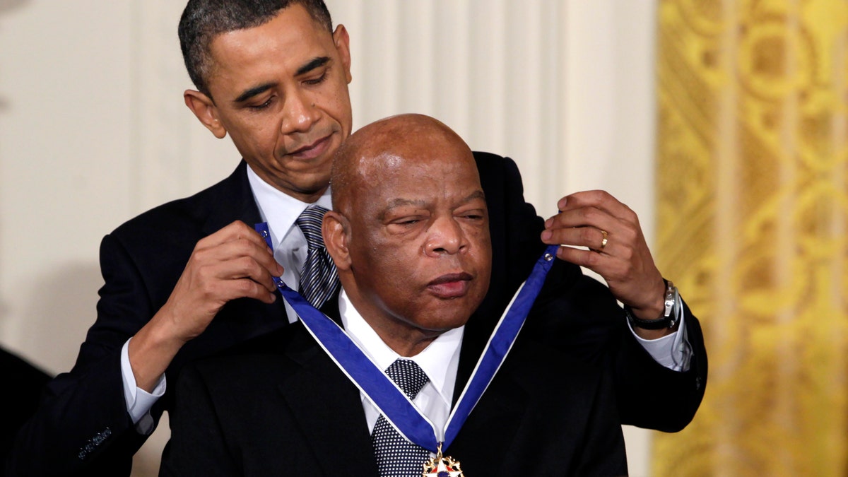 In this Feb. 15, 2011, file photo, President Barack Obama presents a 2010 Presidential Medal of Freedom to U.S. Rep. John Lewis, D-Ga., during a ceremony in the East Room of the White House in Washington. Lewis, who carried the struggle against racial discrimination from Southern battlegrounds of the 1960s to the halls of Congress, died Friday, July 17, 2020. (AP Photo/Carolyn Kaster, File)