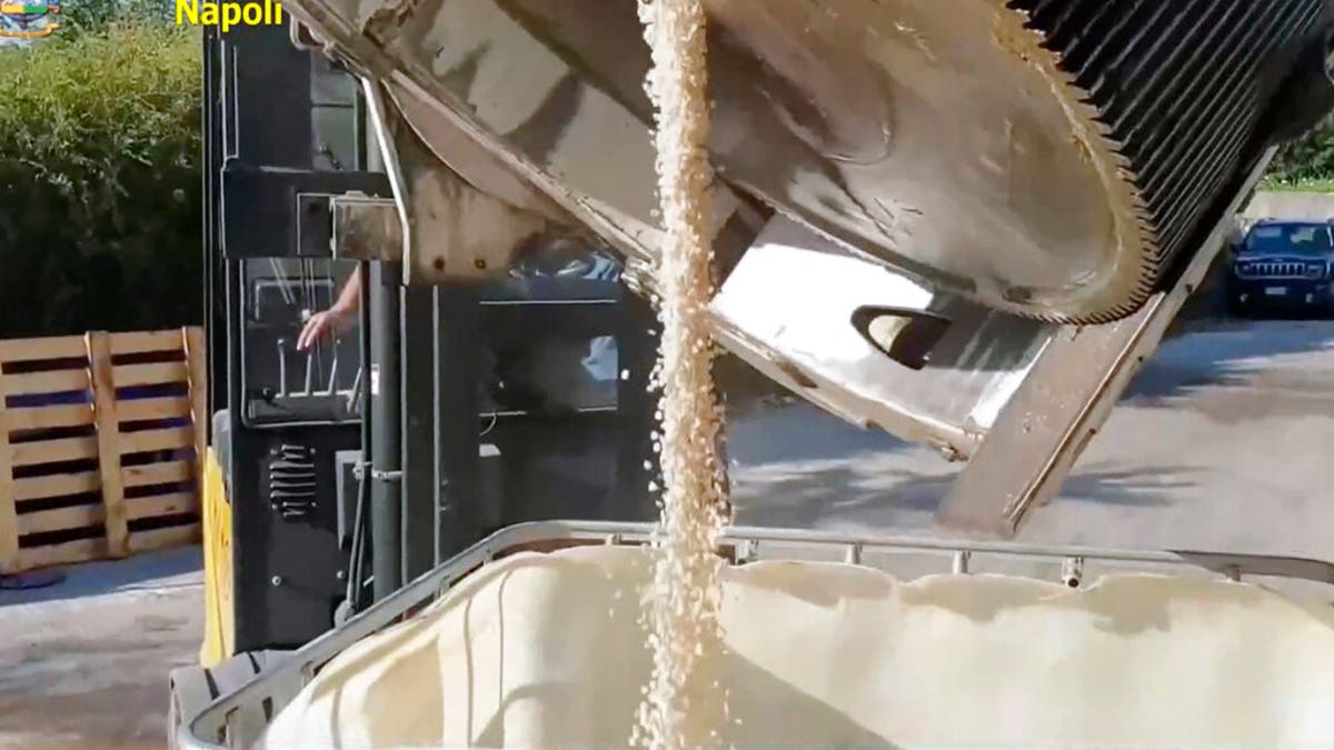 This image taken from a video shows customs police unloading amphetamines that were seized at the Salerno harbor, southern Italy, Wednesday, July 1, 2020. (Guardia di Finanza via AP)