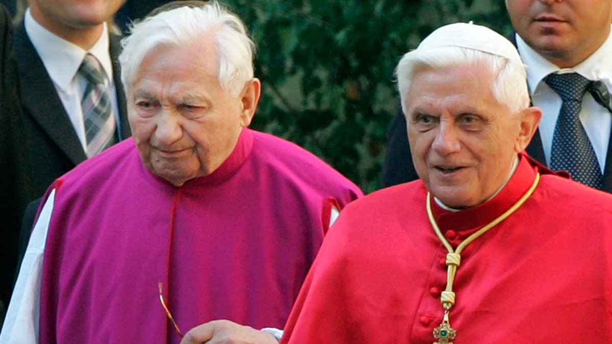 In this Sept. 13, 2006 file picture Pope Benedict XVI, right, walks with his brother priest Georg Ratzinger in Regensburg, southern Germany. The Rev. Georg Ratzinger, the older brother of Emeritus Pope Benedict XVI, who earned renown in his own right as a director of an acclaimed German boys’ choir, has died at age 96. The Regensburg diocese in Bavaria, where Ratzinger lived, said in a statement on his website that he died on Tuesday, June 30, 2020. (AP Photo/Diether Endlicher)