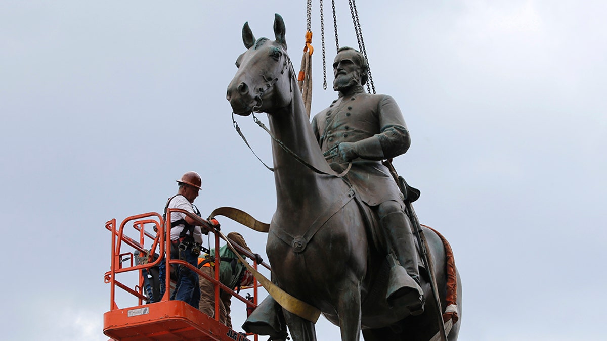 Work crews remove the statue of confederate general Stonewall Jackson, July 1, in Richmond, Va. Richmond Mayor Levar Stoney has ordered the immediate removal of all Confederate statues in the city, saying he was using his emergency powers to speed up the healing process for the former capital of the Confederacy amid weeks of protests over police brutality and racial injustice. (AP Photo/Steve Helber)