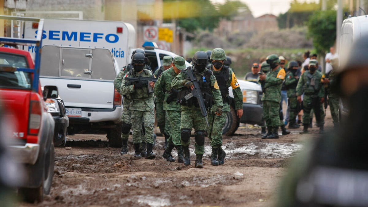 Members of the Mexico national guard walk near an unregistered drug rehabilitation center after a shooting in Irapuato, Mexico, on July 1. The violence occured in a region where the Jalisco New Generation Cartel reportedly is fighting for control of a $3 billion market in stolen gasoline. (AP)
