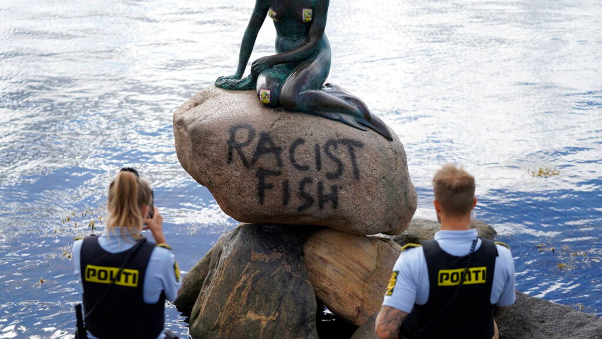 Police stand by the statue of the Little Mermaid, after it was vandalized, in Copenhagen, Denmark, Friday, July 3, 2020. 