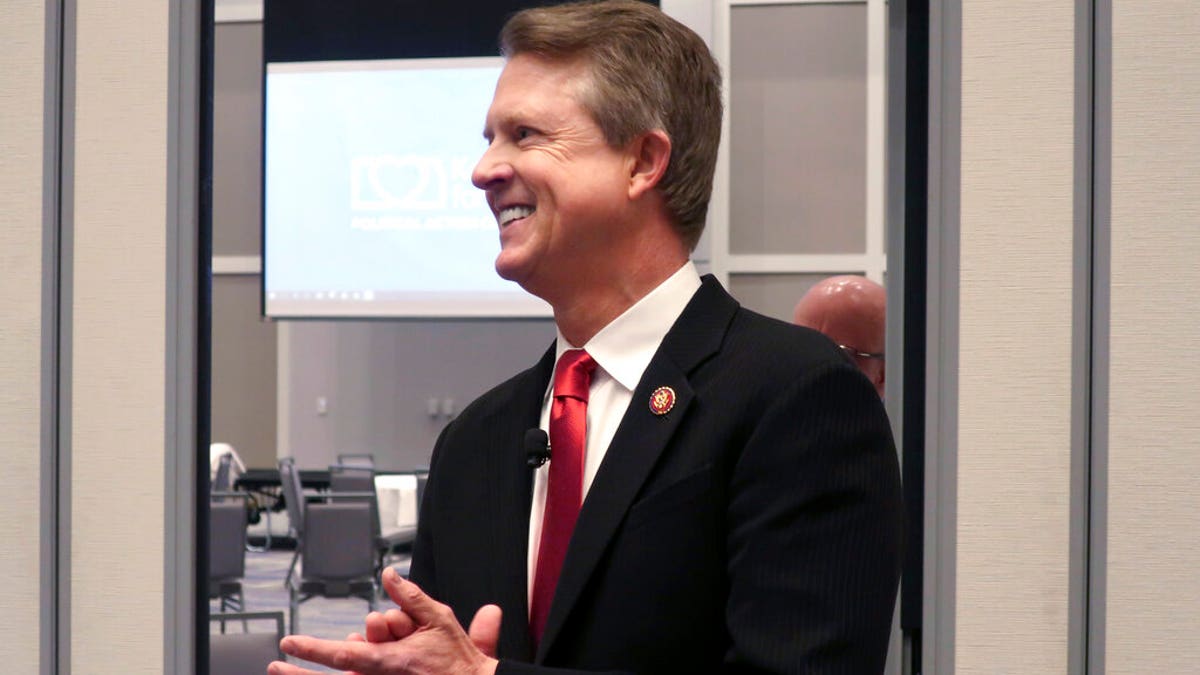 In this Feb. 1, 2020 file photo, U.S. Rep. Roger Marshall, R-Kan., a candidate for the U.S. Senate, awaits the start of a debate in Olathe, Kansas. Establishment Republicans who'd been coy for months about the GOP primary for Kansas' open Senate seat are increasingly putting their thumbs on the scale. They're hoping to push western Kansas Rep. Roger Marshall to victory over polarizing conservative Kris Kobach. (AP Photo/John Hanna, File)