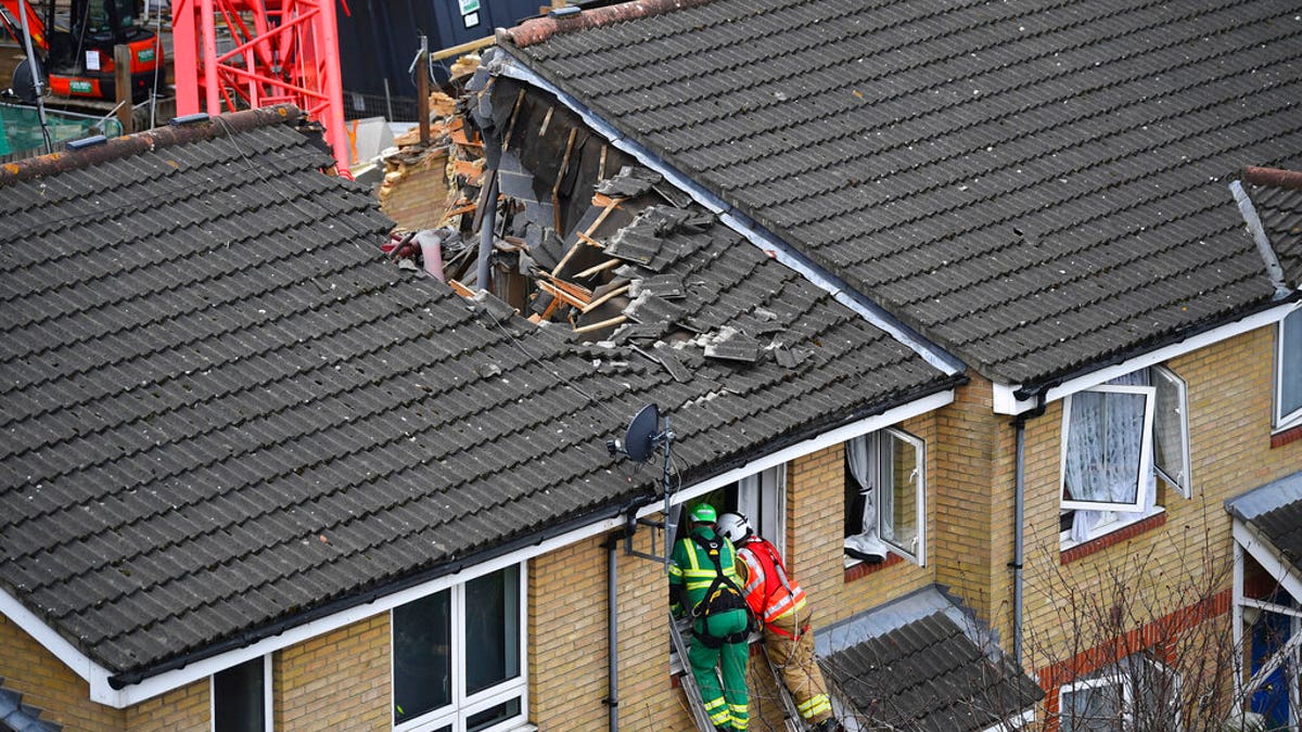 Emergency personnel at the scene in Bow where a 20-metre crane collapsed on to a property leaving people trapped inside, in east London, Wednesday July 8, 2020.