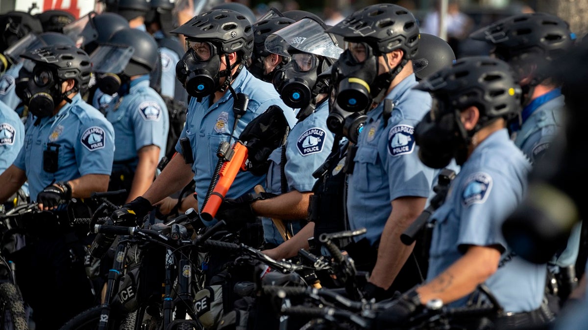 In this May 27, 2020, file photo, police gather en masse as protests continue at the Minneapolis 3rd Police Precinct in Minneapolis. The Minneapolis protests sparked others nationwide. (Carlos Gonzalez/Star Tribune via AP, File)