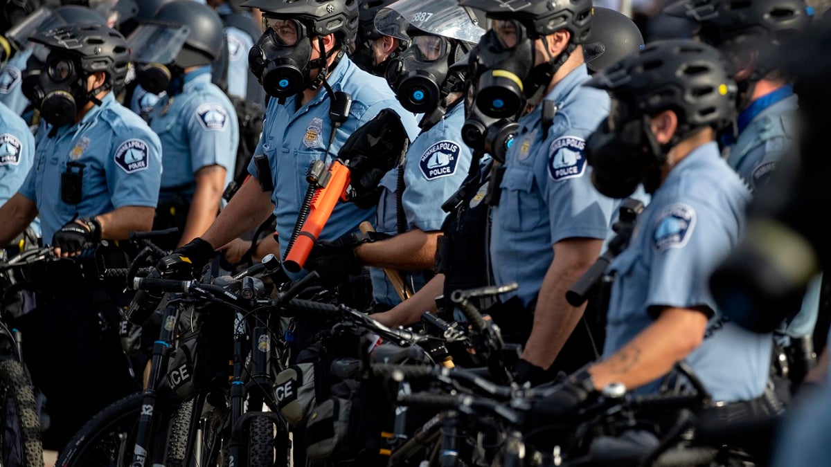 In this May 27, 2020, file photo, police gather en masse as protests continue at the Minneapolis 3rd Police Precinct in Minneapolis. The Minneapolis protests sparked others nationwide. (Carlos Gonzalez/Star Tribune via AP, File)