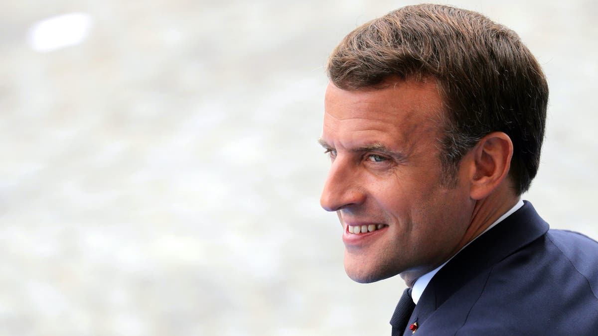 France's President Emmanuel Macron attends the Bastille Day military parade, Tuesday, July 14, 2020 in Paris. France are honoring nurses, ambulance drivers, supermarket cashiers and others on its biggest national holiday Tuesday. Bastille Day's usual grandiose military parade in Paris is being redesigned this year to celebrate heroes of the coronavirus pandemic. (Ludovic Marin, Pool via AP)