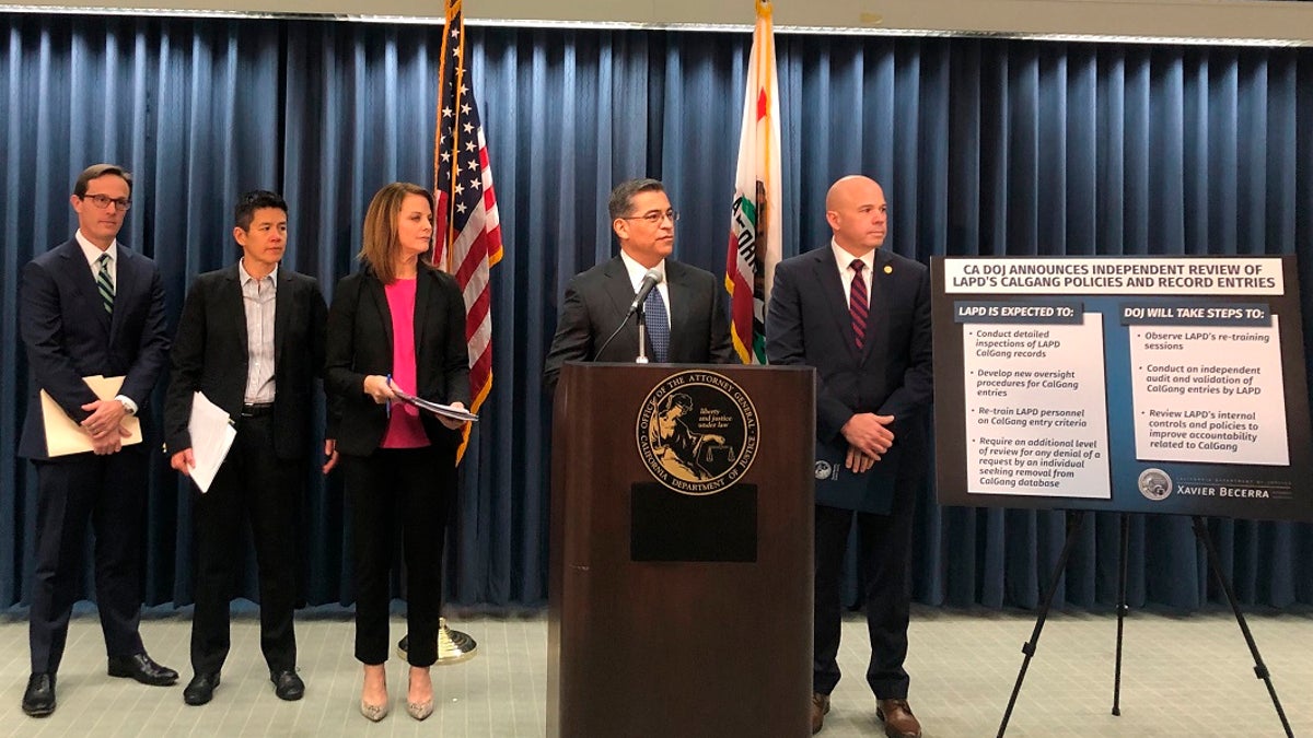 California Attorney General Xavier Becerra, second from right, revoked access to entries Los Angeles police made in the state's gang database after three officers were charged with falsifying records, authorities said Tuesday, July 14, 2020. (AP Photo/Stefanie Dazio, File)