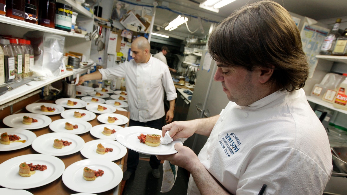 In this 2012 file photo, chef and owner Josiah Slone, right, prepares a foie gras dish at Sent Sovi restaurant in Saratoga, Calif. Foie gras is back on the menu in California after a judge ruled the rich dish can't be prevented from being brought in from out of state. (AP Photo/Marcio Jose Sanchez, File)