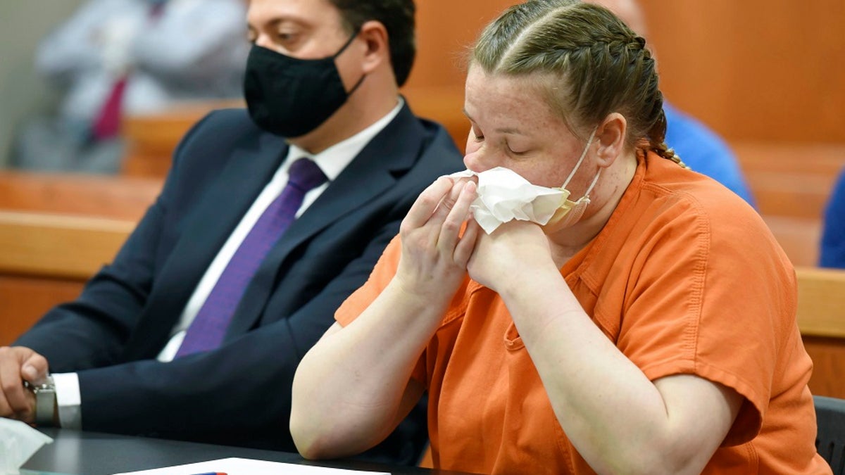 JoAnn Cunningham cries and wipes her nose during her sentencing hearing Thursday, July 16, 2020, in Woodstock, Ill. Cunningham pled guilty in December to killing her five-year-old son Andrew "A.J." Freund in April 2019 in her Crystal Lake home. She was sentenced Friday to 35 years in prison. (John Starks/Daily Herald via AP, Pool)