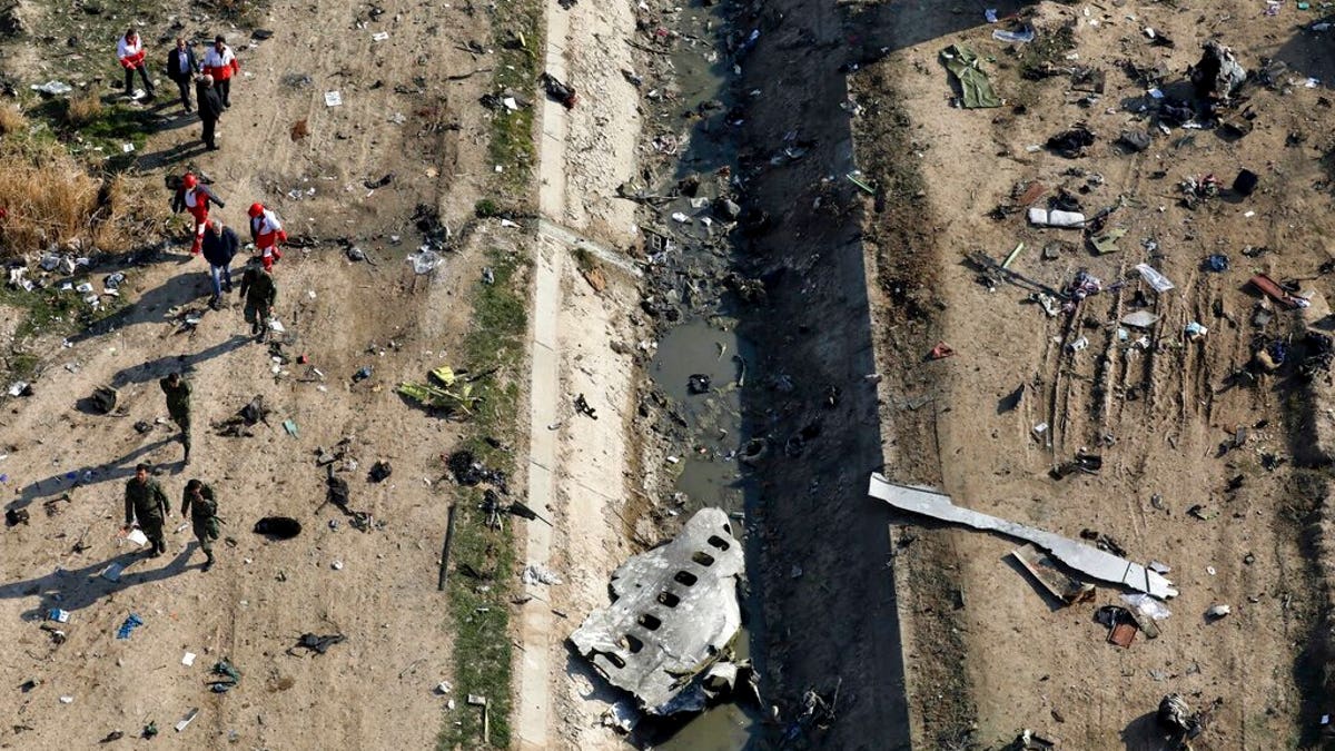 In this Jan. 8, 2020 file photo, rescue workers search the scene where a Ukrainian plane crashed in Shahedshahr, southwest of Tehran, Iran. (AP Photo/Ebrahim Noroozi, File)