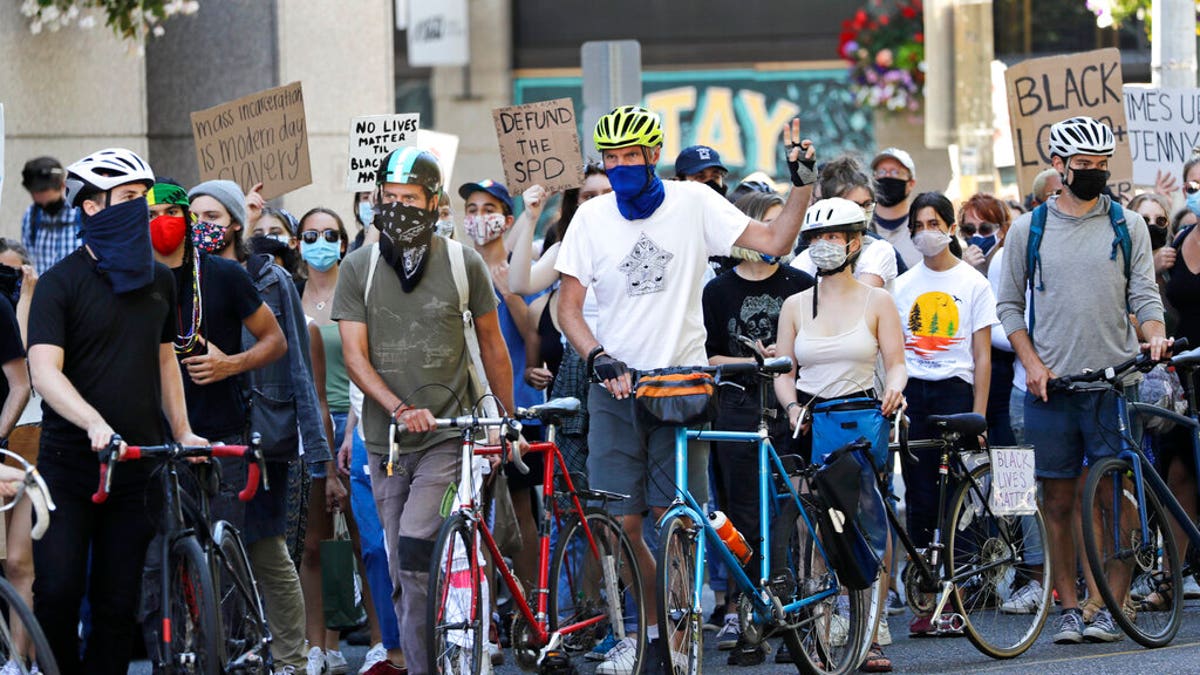 Bicyclists maintain a line to help protect marchers from traffic during a protest led by youth activists demanding racial, climate, economic, worker, and social justice Monday, July 20, 2020, in Seattle. The demonstration follows other protests over the death of George Floyd, a Black man who was in police custody in Minneapolis. 