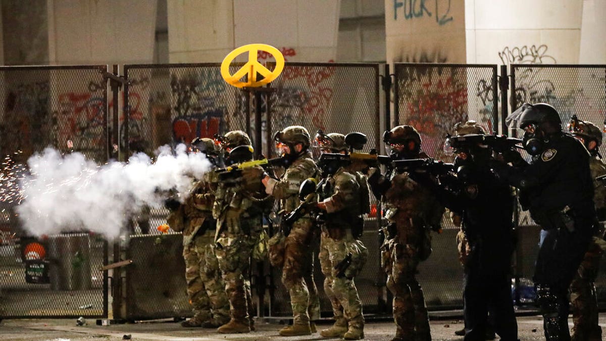 Federal agents use crowd control munitions to disperse Black Lives Matter demonstrators during a protest at the Mark O. Hatfield United States Courthouse Friday, July 24, 2020, in Portland, Ore.?