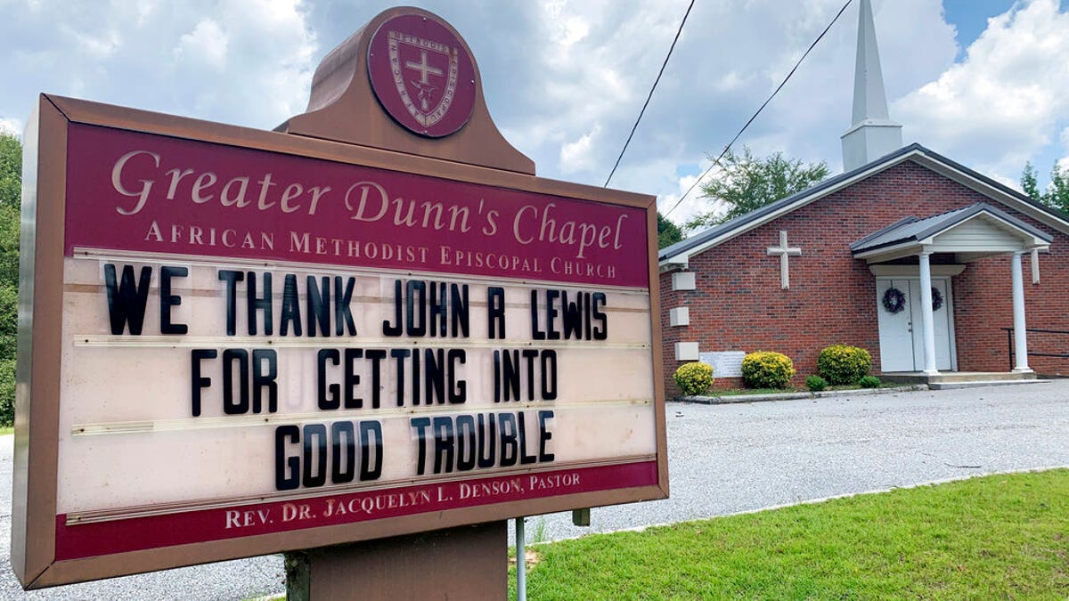 In this July 20, 2020, photo, a church sign honoring the late U.S. Rep. John Lewis sits near his family's land in Pike County, Ala. A series of services will be held to remember Lewis, beginning July 25, 2020, in his home state of Alabama. (AP Photo/Kimberly Chandler)