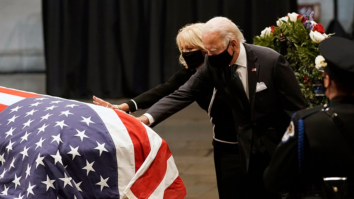 Then-Democratic presidential candidate Joe Biden and wife Jill Biden touch the flag-draped casket of the late Rep. John Lewis, D-Ga., at the Capitol in Washington, July 27, 2020. (Associated Press)