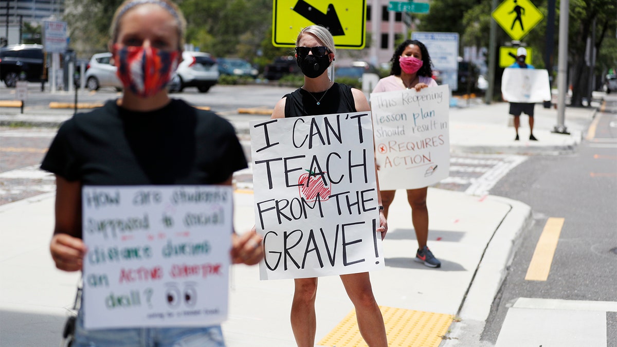 Middle school teacher Brittany Myers, center, protests in front of the Hillsborough County Public Schools office in Tampa, Florida, in July. (Photo by Octavio Jones/Getty Images)