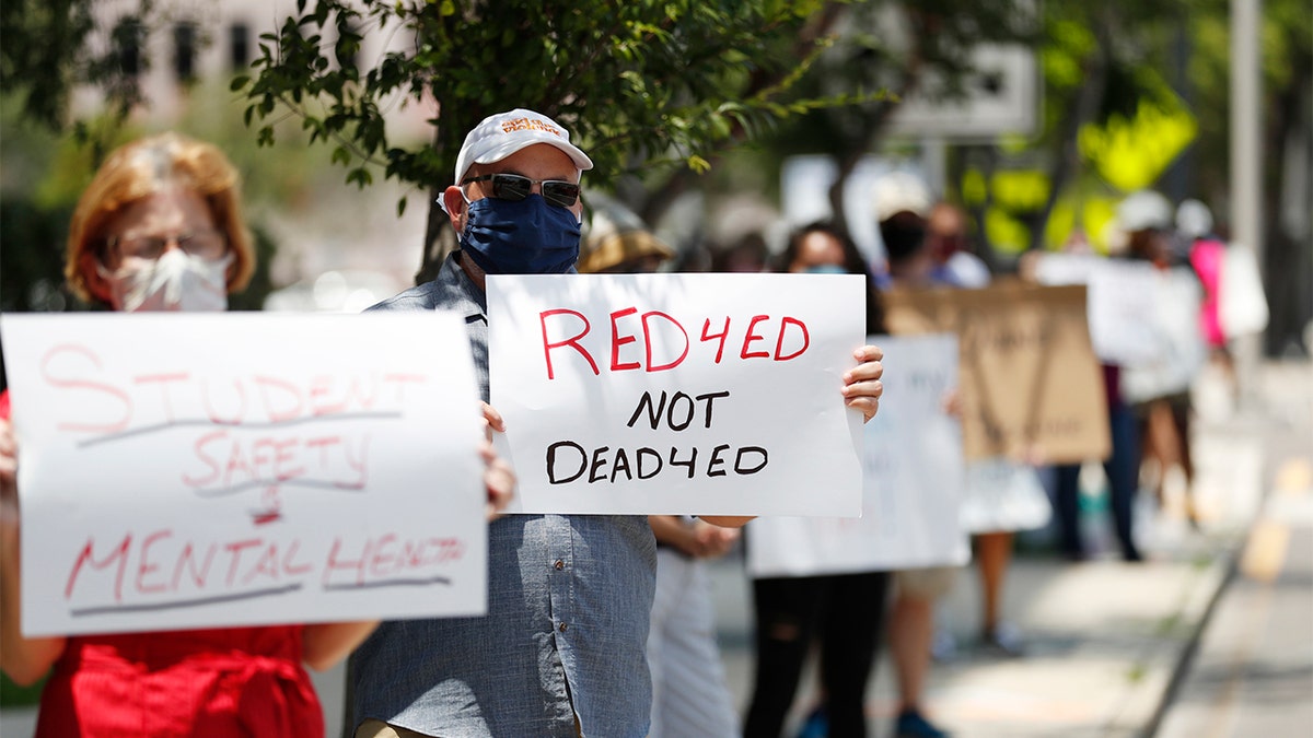 TAMPA, FL - JULY 16: Middle school teacher Scott Hottenstein stand in protest in front of the Hillsborough County Schools District Office on July 16, 2020 in Tampa, Florida. Teachers and administrators from Hillsborough County Schools rallied against the reopening of schools due to health and safety concerns amid the COVID-19 pandemic. (Photo by Octavio Jones/Getty Images)