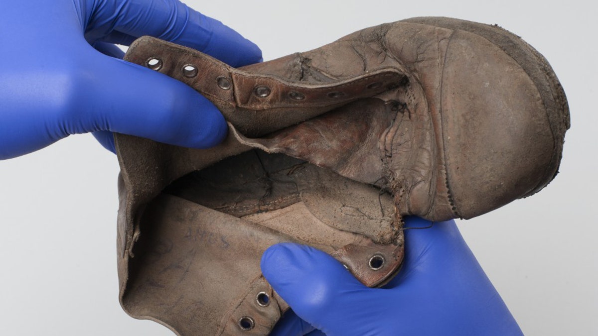 The shoe that belonged to six-year-old Holocaust victim Amos Steinberg. The inscription can be seen inside the show.