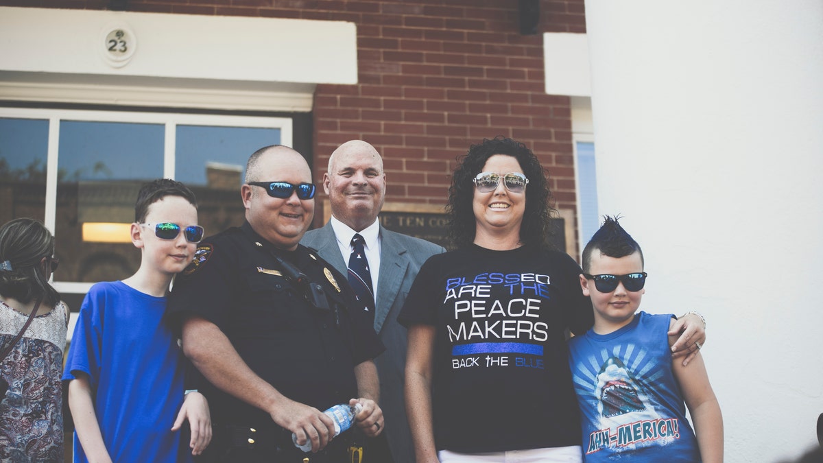 Pastor Perry Cleek pictured with Jonesborough Police Officer, Major Jamie Aistrop and his family during the Independence Day ceremony honoring law enforcement at the Washington County Court House on July 4, 2020.
