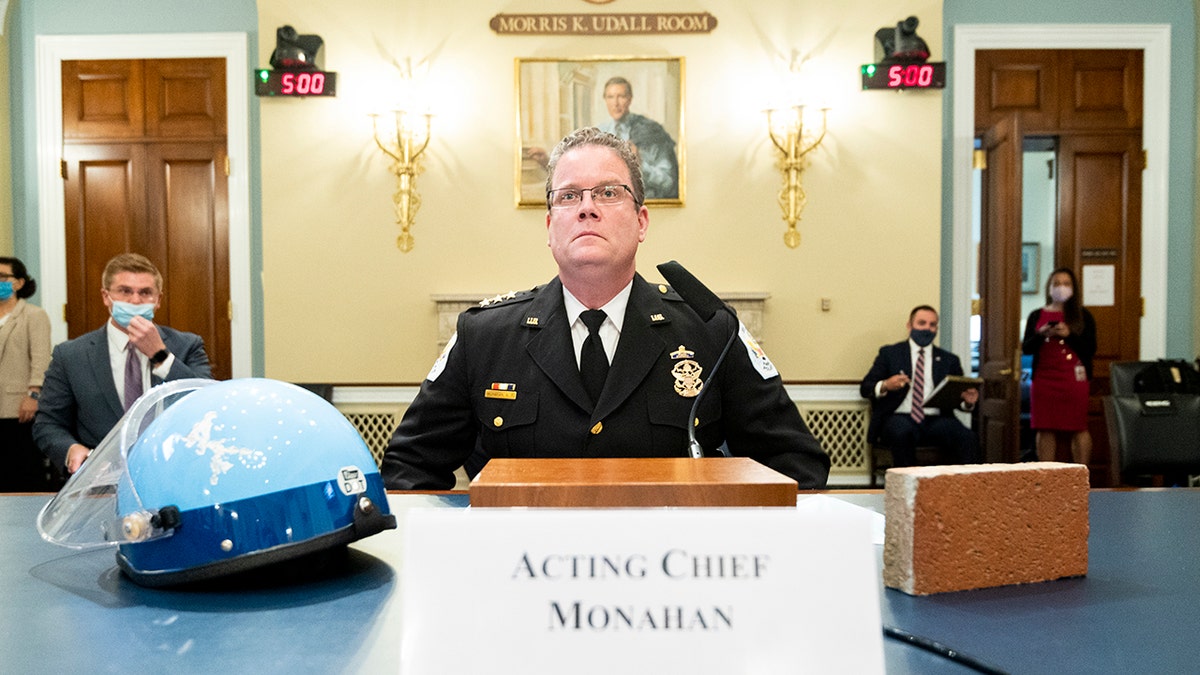 Acting U.S. Park Police Chief Gregory T. Monahan, testifies before a House Natural Resources Committee hearing on actions taken on June 1, 2020 at Lafayette Square, Tuesday, July 28, 2020 on Capitol Hill in Washington. He sits with a helmet of one of the officers who was injured by a violent protester who threw a brick at his head. (Bill Clark/Pool via AP)