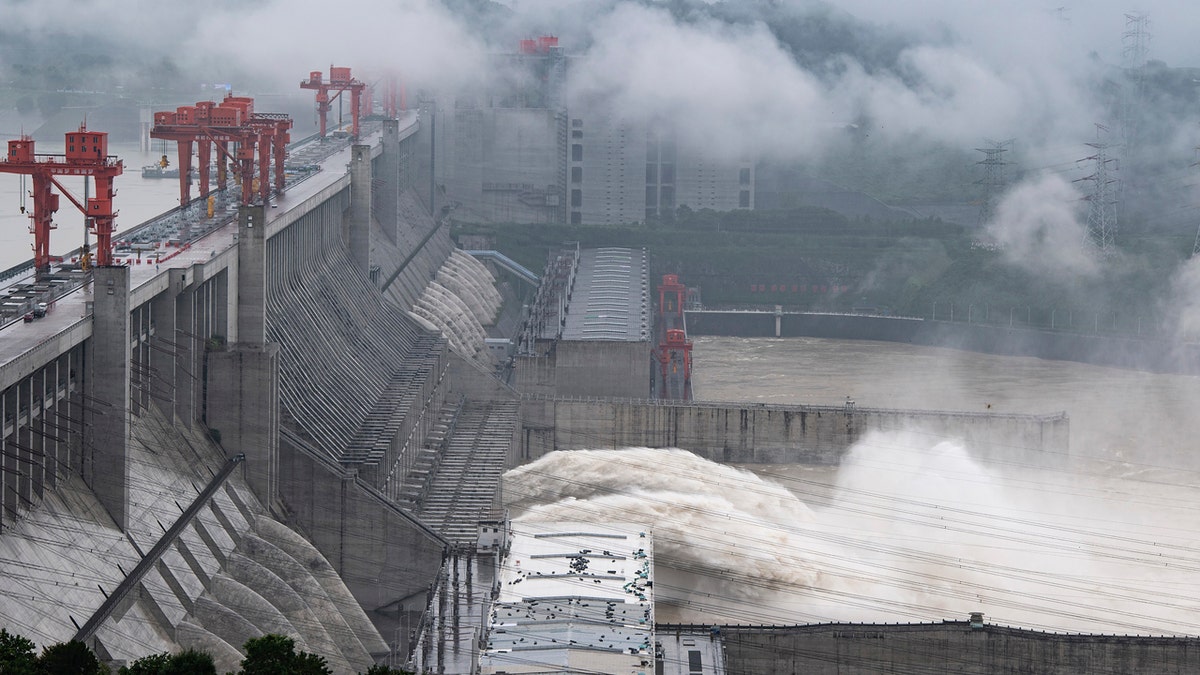 In this photo released by China's Xinhua News Agency, water flows out from sluiceways at the Three Gorges Dam on the Yangtze River near Yichang in central China's Hubei Province, Friday, July 17, 2020.