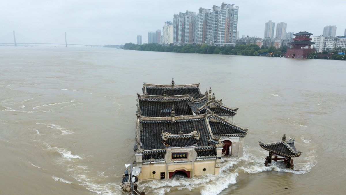The Kwanyin temple built on a rocky island in the middle of the Yangtze River is seen flooded as the water level surge along Ezhou in central China's Hubei province on Sunday, July 19, 2020.
