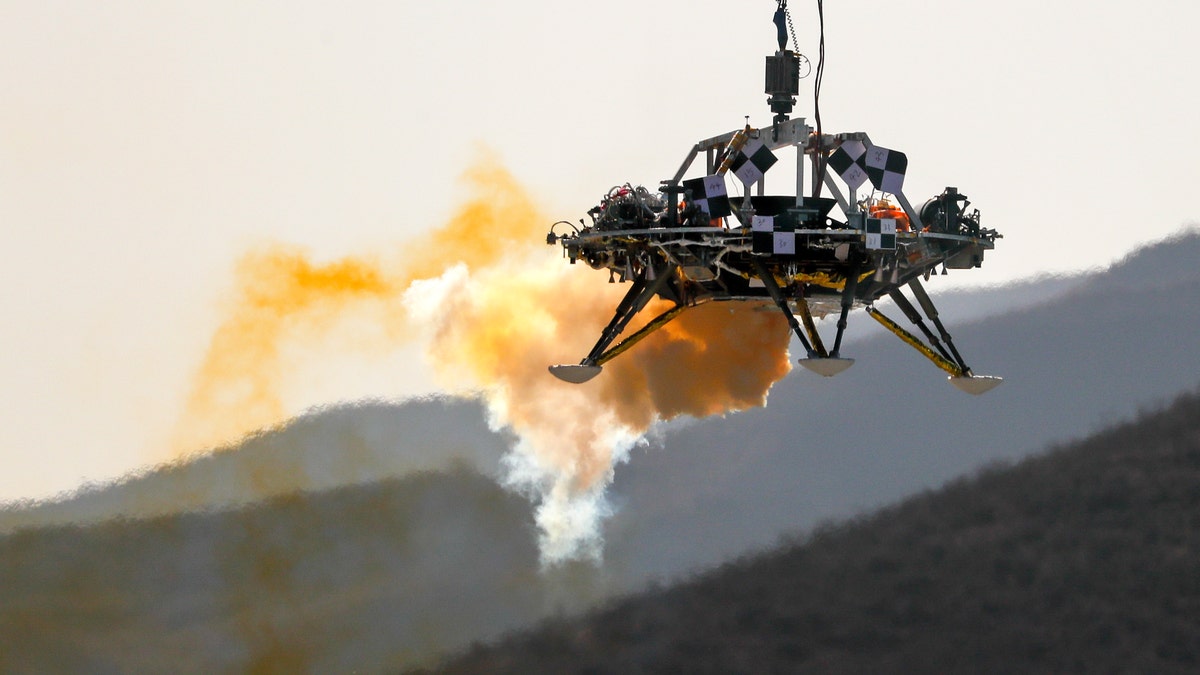 In this Thursday, Nov. 14, 2019 file photo, the Mars lander's hovering, obstacle avoidance and deceleration capabilities are tested at a facility at Huailai in China's Hebei province.