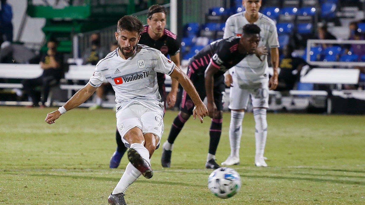 Los Angeles FC forward Diego Rossi (9) scores on a penalty kick against the Seattle Sounders during the first half of an MLS soccer match in Kissimmee, Fla., Monday, July 27, 2020. (AP Photo/Reinhold Matay)