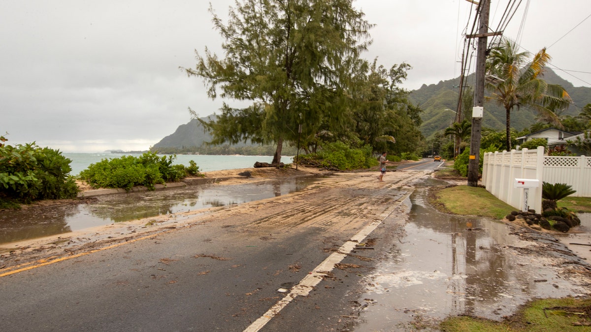 Sand and debris is left on Kamehameha Highway from high surf generated by Hurricane Douglas, Sunday, July 26, 2020, in Hauula, Hawaii.